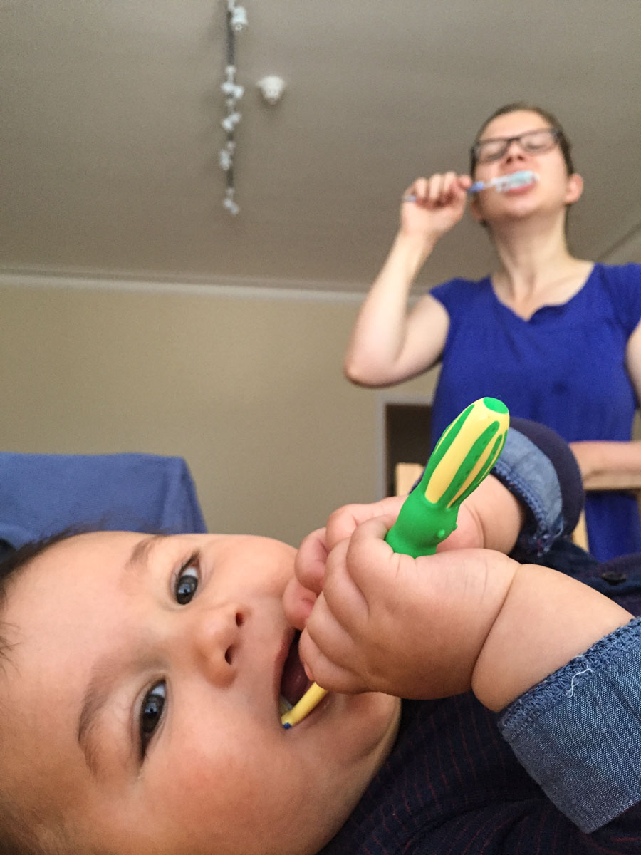 Mama and son brushing their teeth
